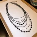 Close-up detail of a vintage multi-layered black necklace featuring faceted glass beads - Layered Necklace / Black