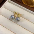 Detailed macro shot of elegant grey pearl earrings with gold-plated zircon stud in box - Real Gold Plated Earrings / 925 Silver Needle / Gray