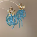 Eleganti orecchini a fiore dorati con nappe a cascata di perline di cristallo azzurro - Stile Nappina Floreale di Perline con Perno in Argento (79#) / Blu - Oro