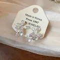 Detailed view of elegant 18k gold plated zircon flower stud earrings with silver needles - Silver Earring Post Style / Silver