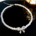 Elegant white pearl choker necklace featuring a sparkling rhinestone bow pendant for women - Style 8 Necklace / White