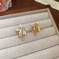 Elegant 18k gold-plated flower stud earrings with sparkling cubic zirconia accents - Clip-on Style / One Pair / Gold-White