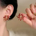 Detailed view of red fireworks stud earrings with zircon accents and gold plating - Style 1 / Gold-Red