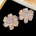 Detailed view of large silver-toned crumpled metal flower stud earrings for elegant women - Pleated Flower Shape / Silver