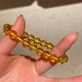 Macro detail view of a translucent orange agate bead bracelet held by hand for display - Style 68 Citrine & Golden Tiger's Eye (With Gift Box) / Yellow Brown