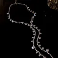 Detailed macro shot of a silver rhinestone tassel necklace with circular crystals - Tassel Necklace / Silver