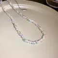 Detail view of a sweet colorful hand-woven seed bead necklace on a beige plate - 米珠编织锁骨链 / Colorful
