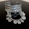 Close-up of vintage silver cuff bracelet with pyramid studs and coin tassel charms - Armlet (HB2313) / Silver