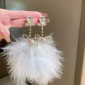Elegant bohemian white feather tassel earrings featuring sparkling crystal bow accents - Bow Silver Earring Post / White