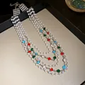 Detail view of a French vintage multi-layer pearl necklace with colorful gemstones. - Silver