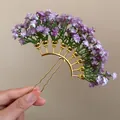 Close-up detail of a golden hair fork with purple baby's breath flower clusters - Purple