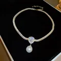 Elegant gold-toned necklace with baguette zircons and a large white teardrop pearl. - 36# Drop Pearl Zirconia Necklace