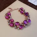 Elegant vintage court style rose gold bracelet featuring purple cabochon stones and clear crystals - Bracelet / Gold-Purple
