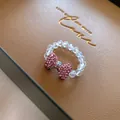 Elegant beaded ring featuring a sparkling pink rhinestone bow centerpiece. - Style 14 (HR1940)