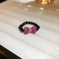 Beaded elastic ring featuring pink rhinestone bow and black faceted beads for women - Style 15 (HR1940)