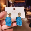 Elegant vintage Klein blue textured resin stud earrings with polished gold-tone metal finish - Irregular Wave Shape / Klein Blue