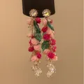 A close-up detail view of colorful floral dangle earrings featuring roses and crystals. - Resin Rose Flower Tassel (HE25056) / Pink-Red