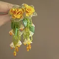 Detail shot of handcrafted yellow rose earrings with green bead tassels and flower charms. - Green Tassel Flower (HE25073) / Yellow-Green (7#)