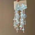 Close-up detail view of elegant light blue acrylic flower tassel earrings with beads - Acrylic Tassel Flower Style (20#) / Blue