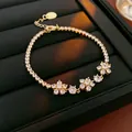 Élégant bracelet doré avec motifs de fleurs en zircon étincelants, style de luxe français. - Style Fleur / Or