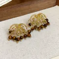 Detail of vintage firework earrings with sparkling rhinestones and tiger eye stone beads - Firework Tassel Style / Coffee