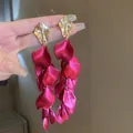 Detailed macro view of elegant rose red fabric petal tassel earrings with gold leaf tops. - Gold Leaf Rose Red Petal Tassel