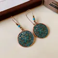 Close-up of bohemian hollow flower earrings with turquoise beads and copper finish. - Ear Hook Round Flower Enamel Style (HE21912) / Green