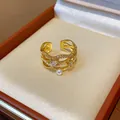 Close-up of a 18k gold-plated wavy ring featuring white pearls and zircon in a gift box - Wave Layered Open Design / Adjustable Open / Gold