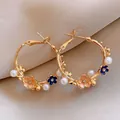 Elegant gold-toned hoop earrings with peach enamel flowers and white faux pearls - Style 12 Enamel Floral Hoop