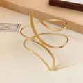 Detailed view of minimalist gold-finish leaf-shaped open cuff bracelet for women - Circular Curve / Gold