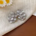 Elegant silver-toned multi-petal cluster flower stud earrings with a textured finish. - Stacked Metal Disc Flower Style / Silver (54#)