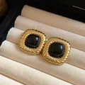 Primo piano di orecchini vintage quadrati dorati con trama intrecciata e pietra nera - Stile Rugoso Quadrato (WE5265) / Nero