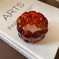 Vintage amber tortoiseshell elastic bracelet with oval links displayed on a beige book - Coffee Style 5