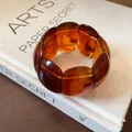 Close-up of vintage amber marbled oval elastic bracelet with artistic textures - Coffee Style 4