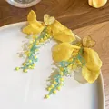 Detailed view of yellow fabric flower earrings with green beaded tassels on a white plate - 39# (Bright Yellow Heart Style)