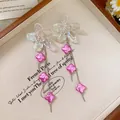 Iridescent flower earrings featuring silver needles and pink clover long drop pendants. - Phantom Flower Clover Long Earrings (32#) / White-Pink (32#)