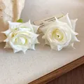 Close-up detail of elegant white fabric rose stud earrings with dew drop bead accents - Light Yellow