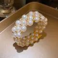 Macro detail of a vintage three-layer pearl bracelet with sparkly rhinestone settings - 3-Layer Bracelet / Gold
