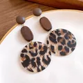 Detail view of vintage leopard print acrylic and dark wood drop earrings on a white plate - Silver Needle - Coffee - Large / Large / Brown