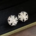 Detailed close-up of intricate silver flower cluster clip-on earrings on black velvet - Flower Cluster Style Ear Clip / Silver