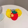 Vibrant yellow fabric scrunchie featuring a cute red strawberry charm with flower detail - Strawberry Flower Style