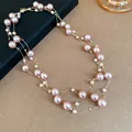 Detail of layered pink pearl necklace with gold chains for an elegant vintage look. - Champagne Glass Bead Style