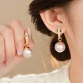 Elegant gold snake head pearl drop earrings with green eyes for variant selection - Snake Head Pearl Drop Style / Gold