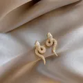 Elegant gold-tone snake stud earrings featuring pavé crystals and a teardrop stone detail - Teardrop Stone Snake Stud / Gold