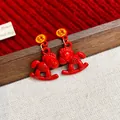 Festive red enamel rocking horse dangle earrings with Chinese character for luck - Prosperity Horse Style / Red