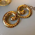 Modern spiral-shaped hoop earrings featuring a vibrant leopard print on gold-tone metal - Spiral Leopard Style / Leopard Print Gold