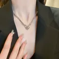Cyberpunk silver Sphynx cat head necklace with blue eyes worn on a black blazer. - Necklace / Silver
