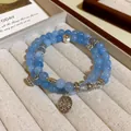 Elegant handmade double-strand blue beaded bracelet with vintage silver lotus and coin charms - Style 81 Blue Aquamarine Compass Lotus