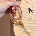 Handmade Neo-Chinese strawberry quartz beaded bracelet with natural crystal and tassel detail - Style 86 Red Glaze (Tassel)