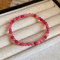 Handmade stretch beaded bracelet with pink strawberry quartz beads in a jewelry display. - Style 103 Pink (Strawberry Style)